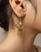Moonstone gold tassel earrings worn on ear