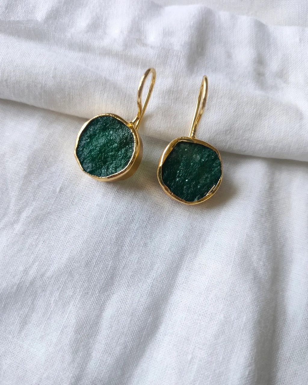 Green raw stone gold drop earrings - front view