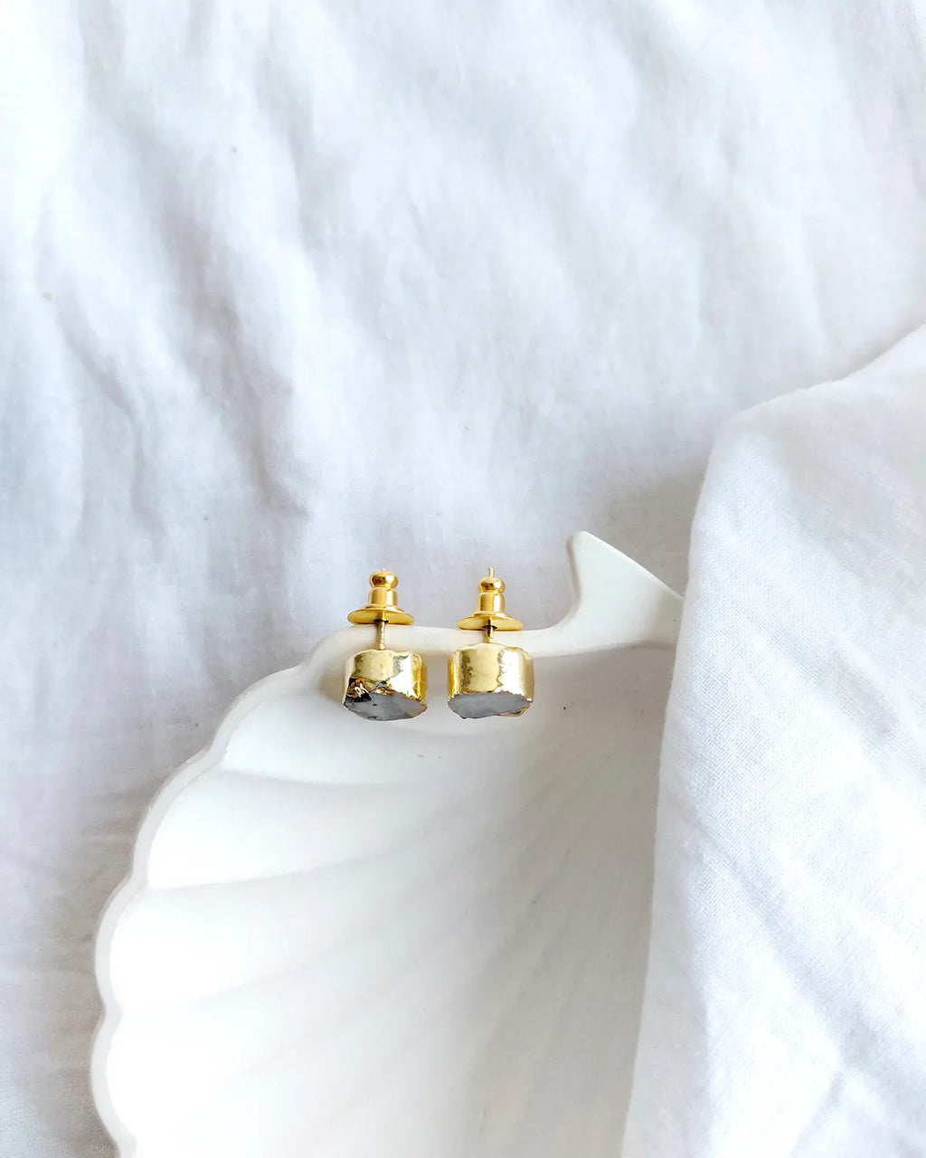 Natural grey stone gold stud earrings angled