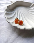 Peach raw stone gold stud earrings front view