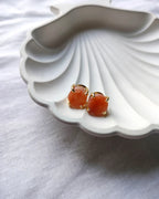 Peach raw stone gold stud earrings front view