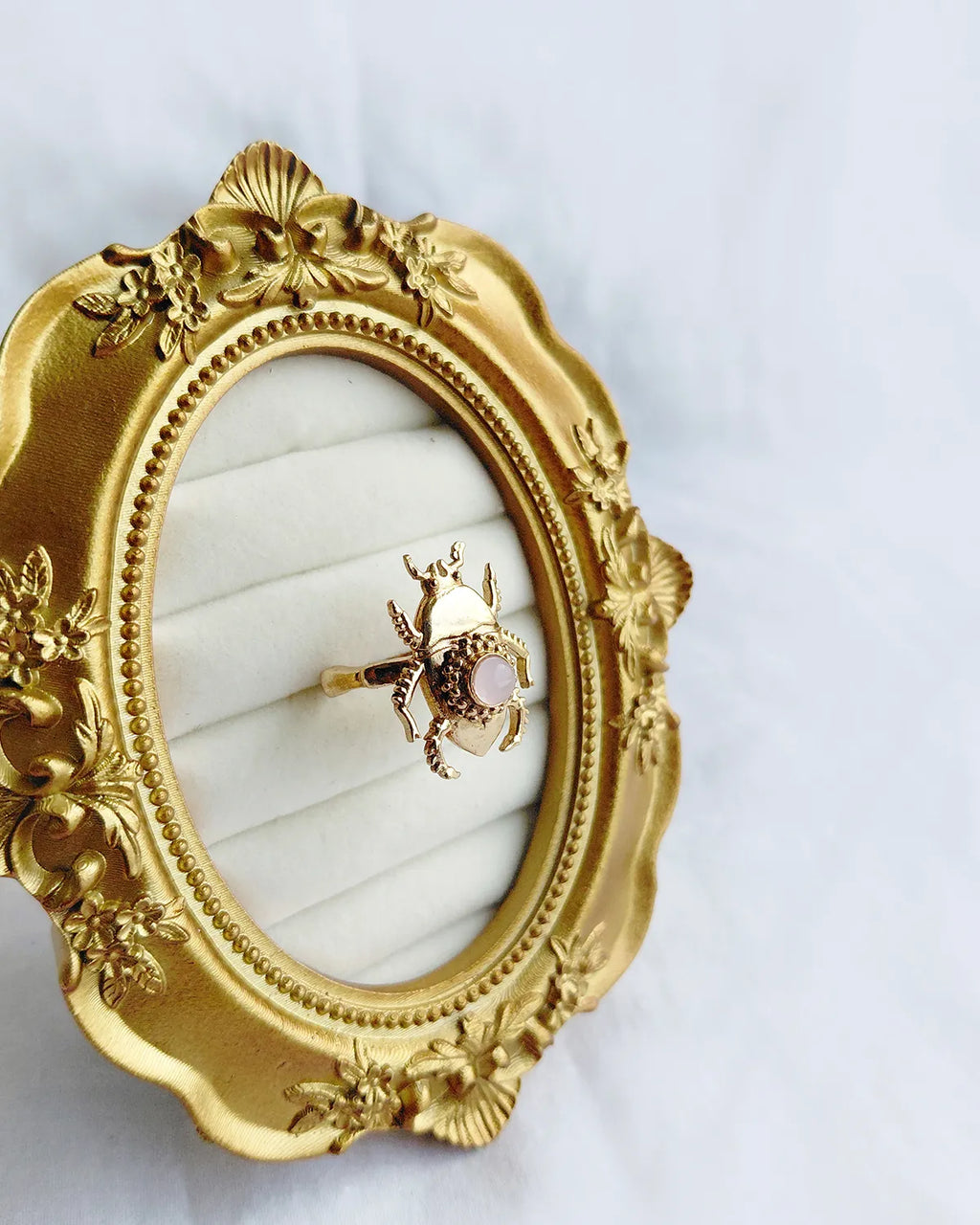 Pink stone scarab gold plated ring angled view