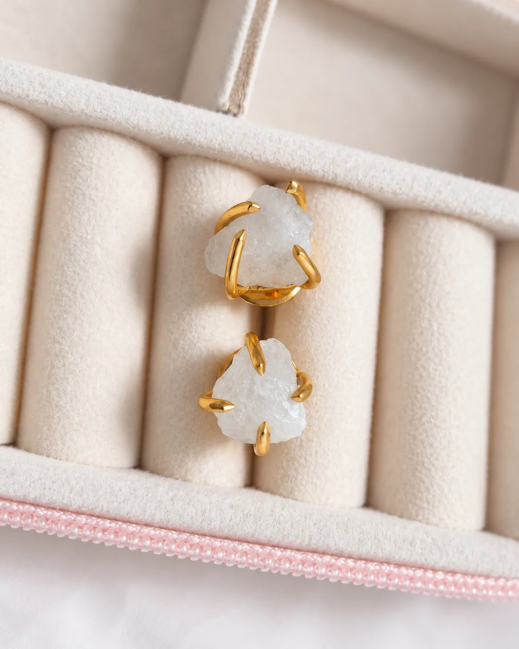 Raw white crystal gold stud earrings close-up in jewelry box