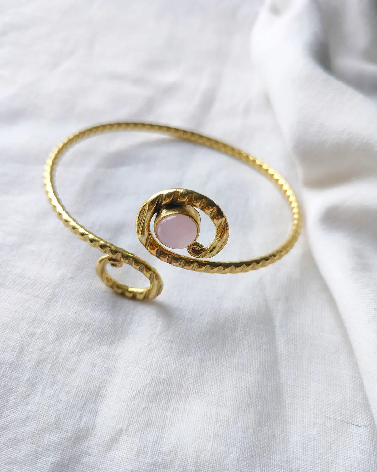 Rose quartz spiral gold cuff bracelet angled view