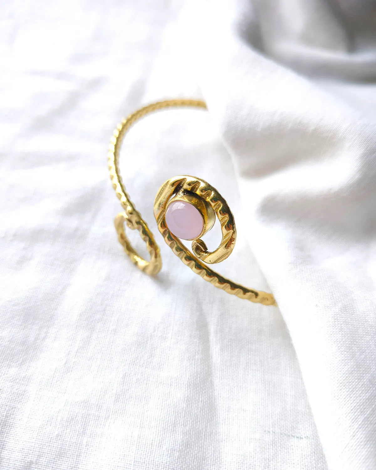 Rose quartz spiral gold cuff bracelet close-up