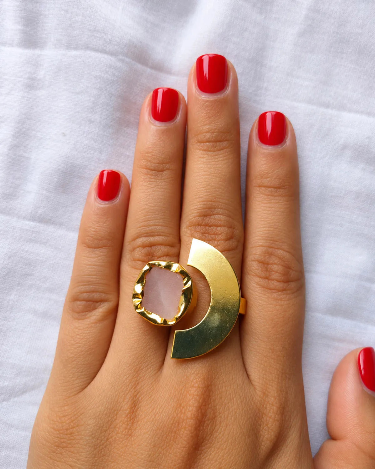 Rose quartz statement ring worn on hand