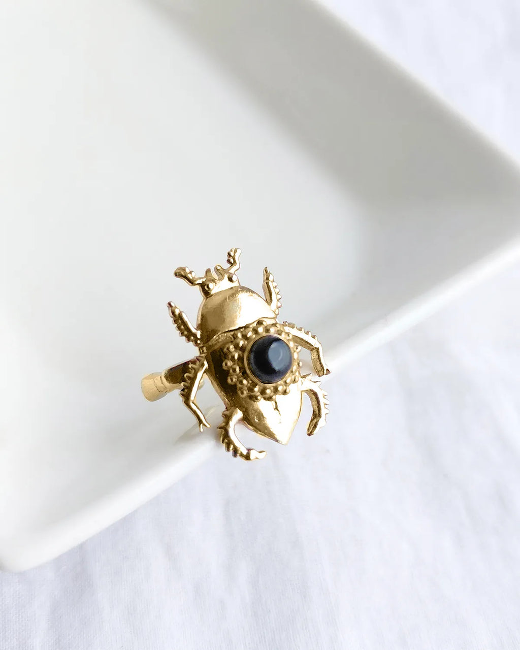 Scarab Muse gold plated ring with black stone front angle