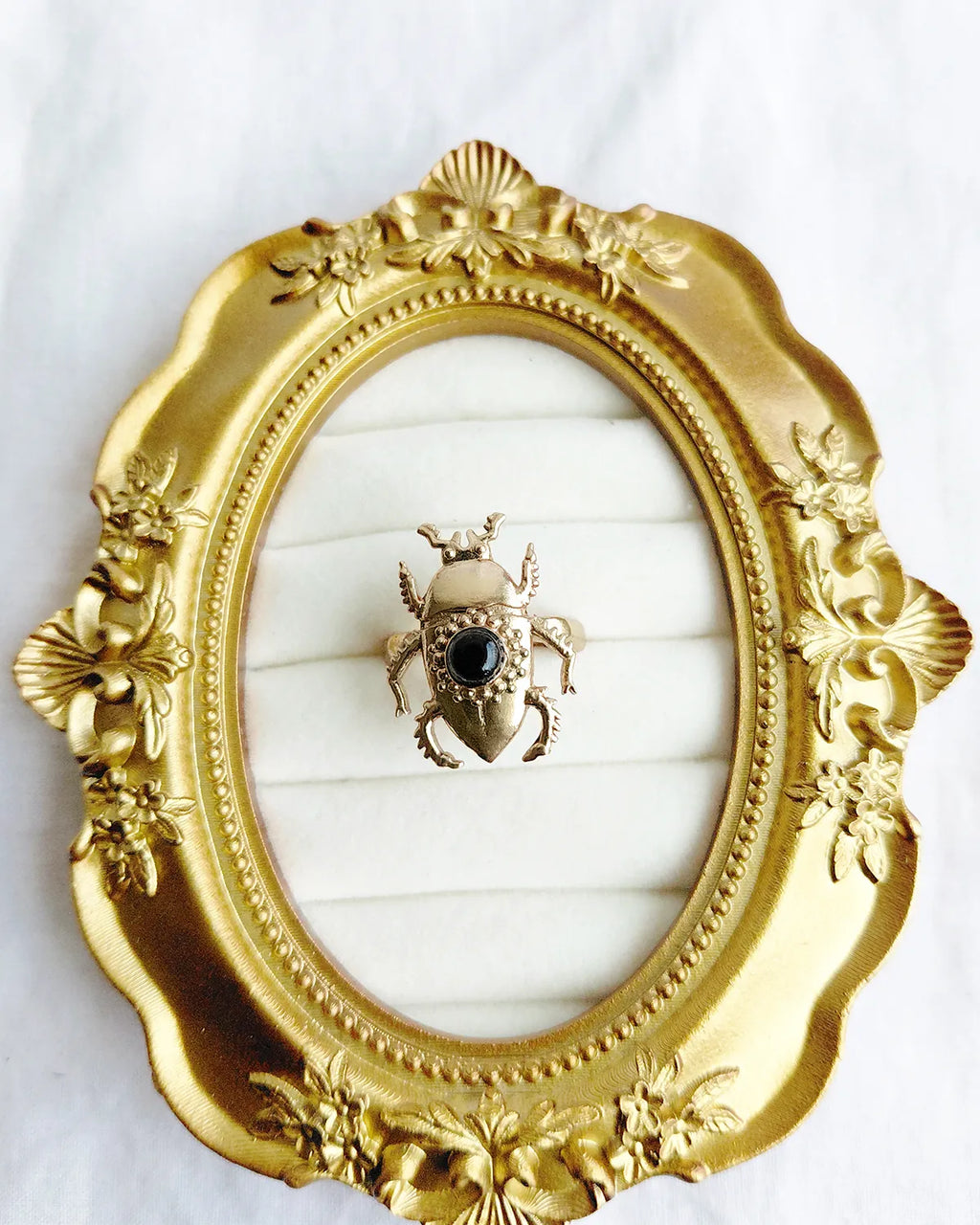 Scarab Muse gold plated ring in ornate gold frame display