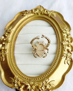 Scarab Muse gold plated ring back view in ornate gold frame