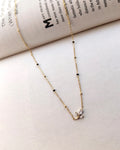 Floral sprig pendant mangalsutra with delicate black beads and gold-tone chain