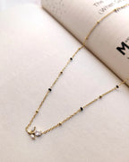 Floral sprig pendant mangalsutra with delicate black beads and gold-tone chain
