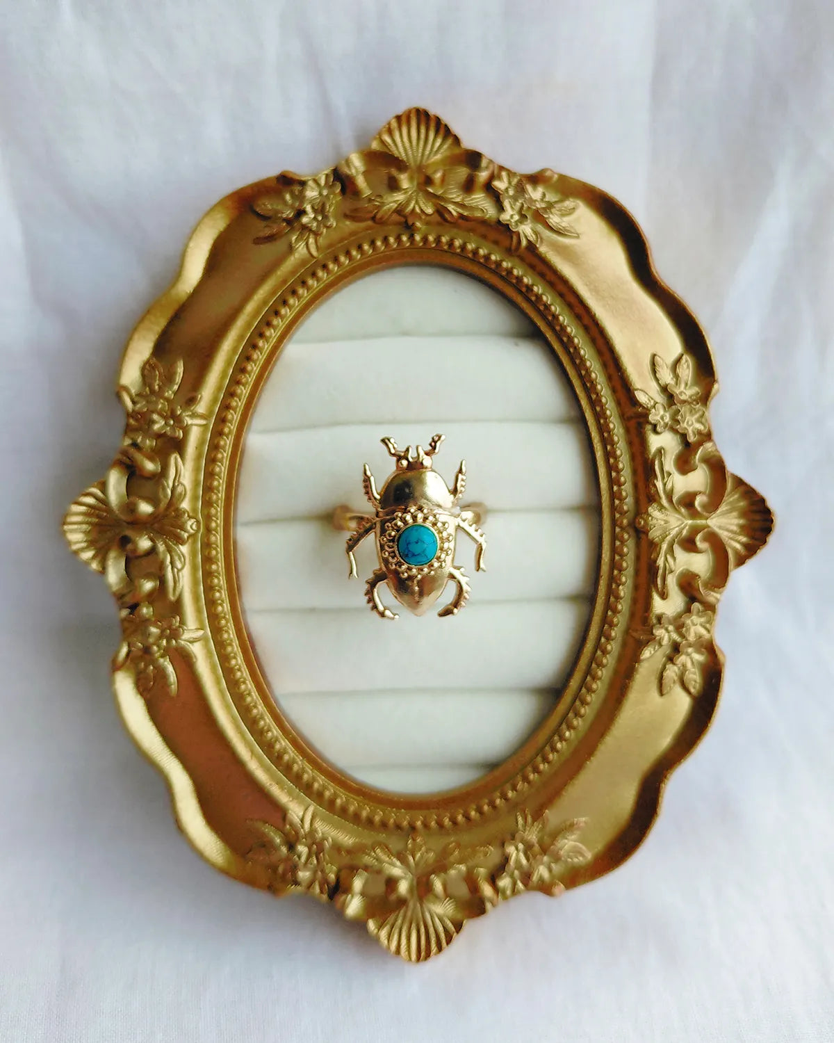 Turquoise blue scarab gold plated ring in ornate gold frame
